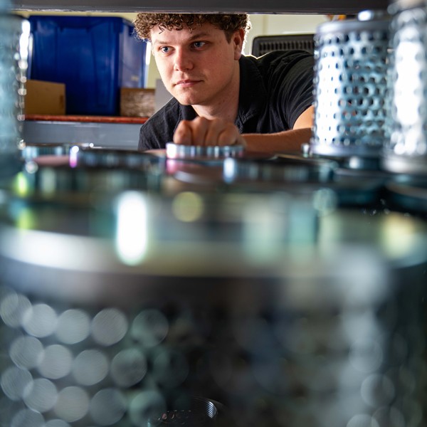 Evan Hall, CSR Inside at National Hose & Equipment Ltd, is using the tagging hose machine.